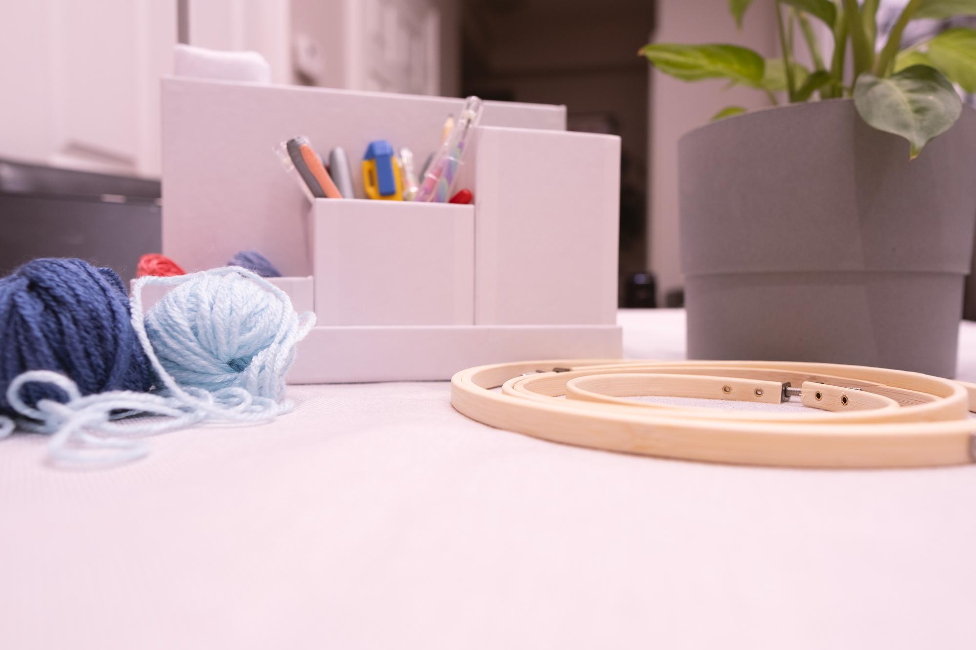 Angolo atelier con luce naturale e strumenti da ricamo
